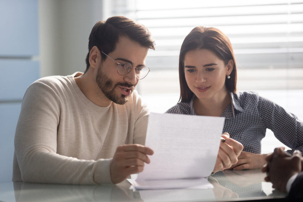couple looking at a report sitting at a table